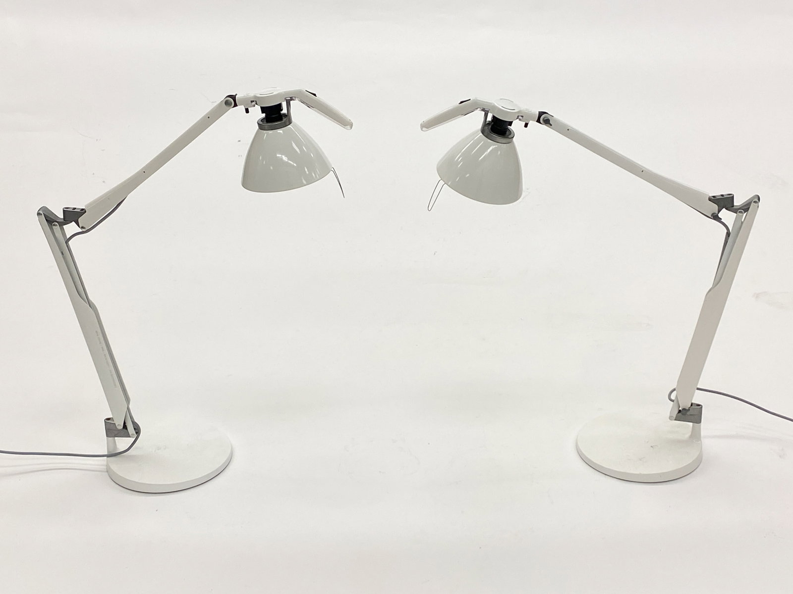 LUCEPLAN FORTEBRACCIO D22 ITALIAN LAMPS: Two lamps designed by Alberto Meda and Paolo Rizzatto for Luceplan. Marked to spot above shade. Adjustable height and positioning. Dimensions: H 24.5" x W 20" x Dia. Base 9.75" Condition: Wear