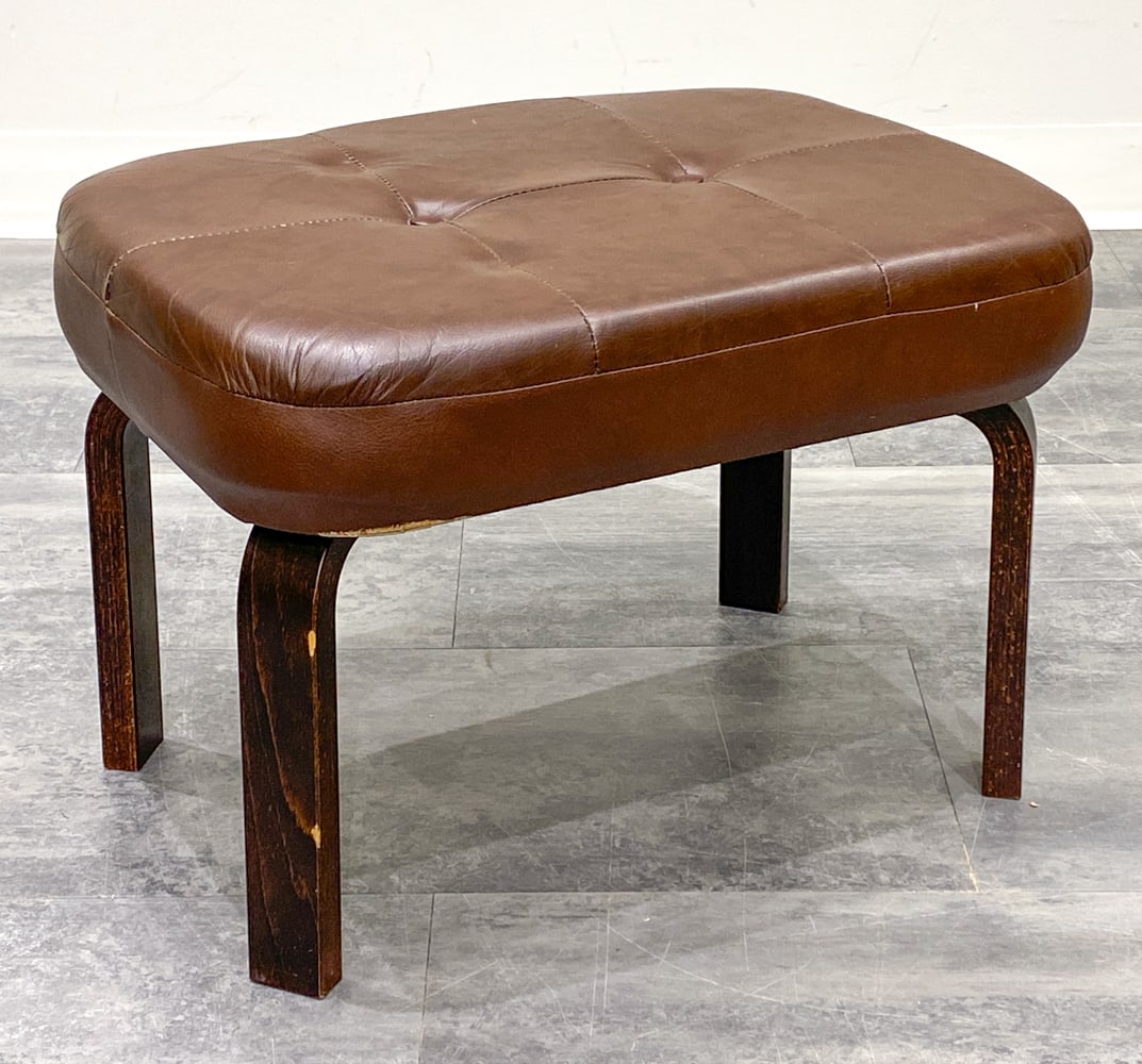 MID-CENTURY SCANDINAVIAN BEECH STOOL C. 1960S: Bentwood beech legs and faux leather upholstery. Dimensions: H 14.5" x W 20" x D 13" Condition: Wear consistent with age and use. Tear to bottom edge. Two dings to one leg.