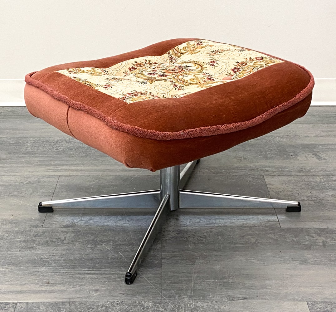 VINTAGE DANISH CHROME OTTOMAN C. 1960S: Pink upholstery and flower motif. Denmark, circa 1950s. Dimensions: H 15" x W 23" x D 20" Condition: Wear consistent with age and use. Fading,