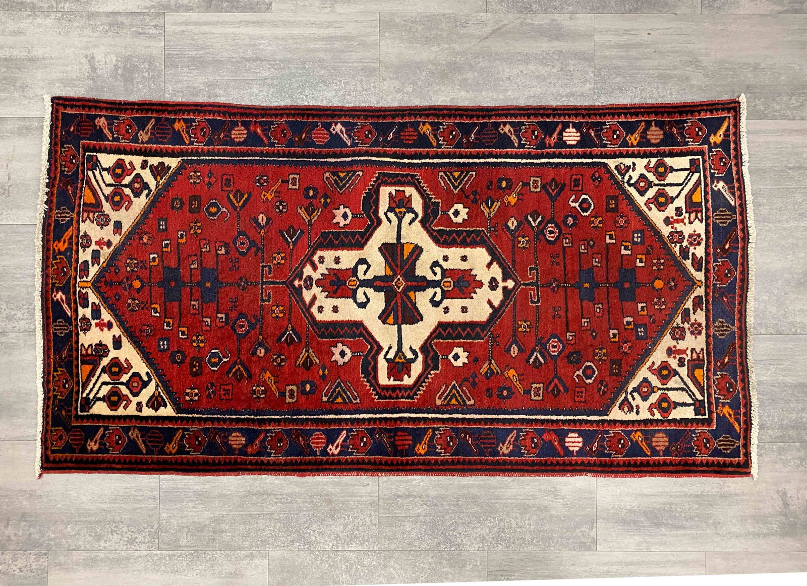 VINTAGE PERSIAN WOOL RUG C. 1960S: Marked underneath. Dimensions: H 79" x W 41.5" Condition: Wear consistent with age and use. Minor discoloration spot, light fading, couple off marks.