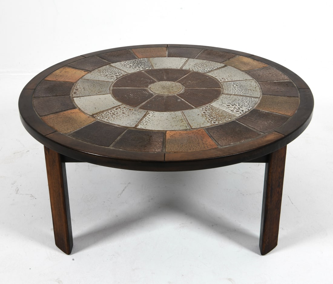 TUE POULSEN DANISH OAK & TILE COFFEE TABLE 1970S: For Haslev. Round oak coffee table with stone tiles inlaid to top. Remnants of mark to underside. Denmark, circa 1970s. Dimensions: H 20" x Dia. 40". Condition: Few scuffs and dings to wood, wear
