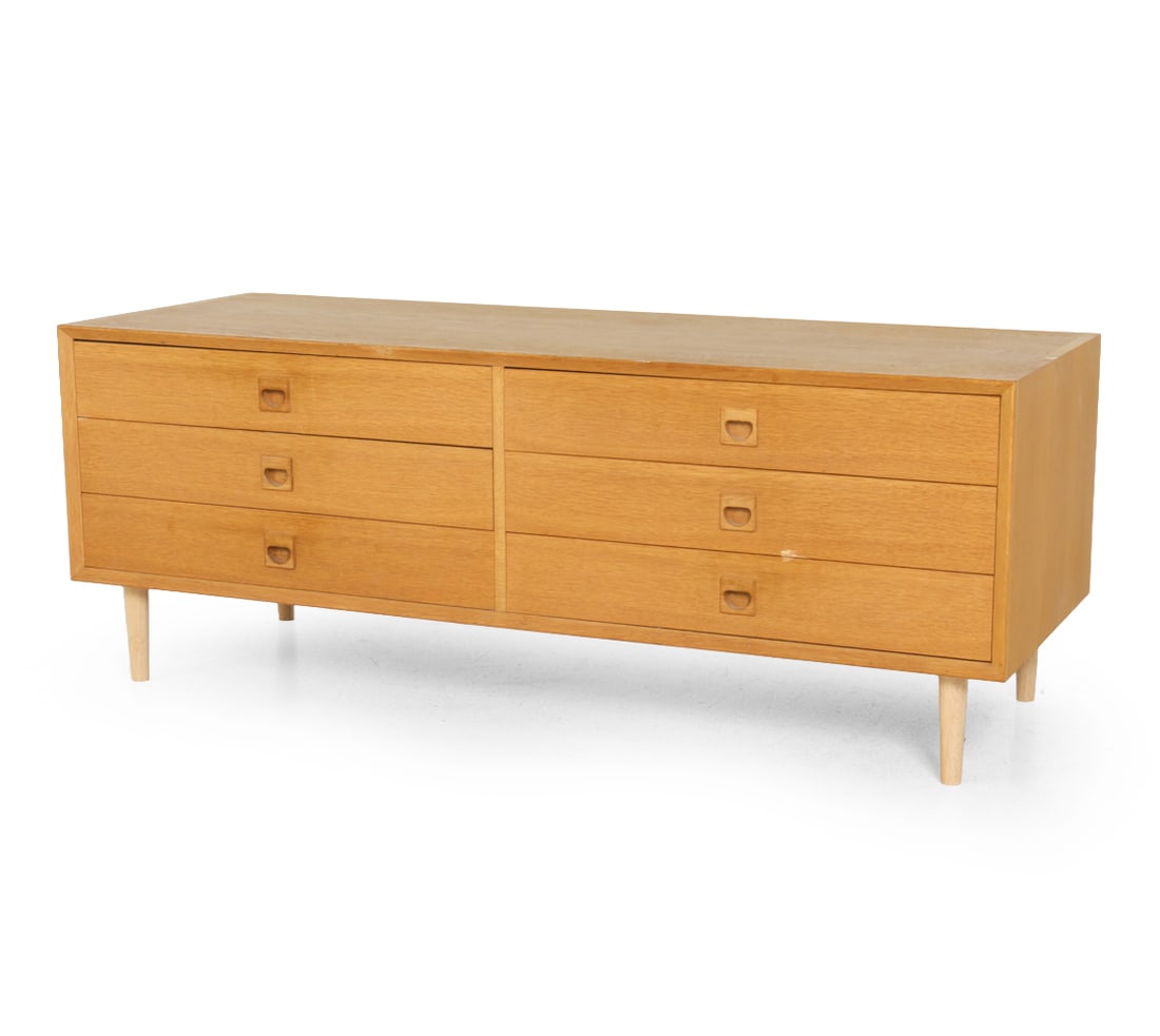 ERIK BROUER DANISH OAK CHEST C. 1960S: 6 Drawer chest with carved pulls. Marked to back. Denmark, circa 1960s. Dimensions: H 20.25" x W 53" x D 19.75" Condition: Minor scuffs, chips to edges, loss to finish. Wear consistent with age and