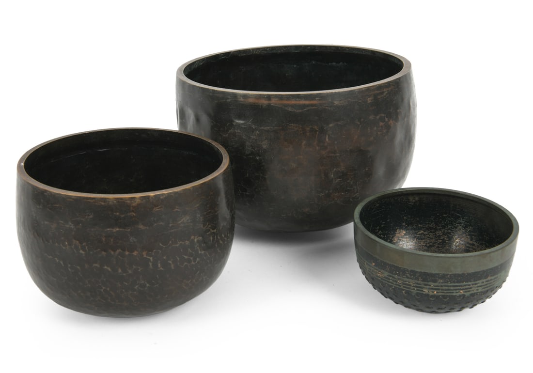 JAPANESE STYLE BRONZE SINGING BOWL GROUPING: (3) total graduated bowls. Textured bronze construction. 20th century. Dimensions: (Largest) H 6" x Dia 8.5" Condition: Surface marks, scratches, oxidation, and finish loss. Interior wear and