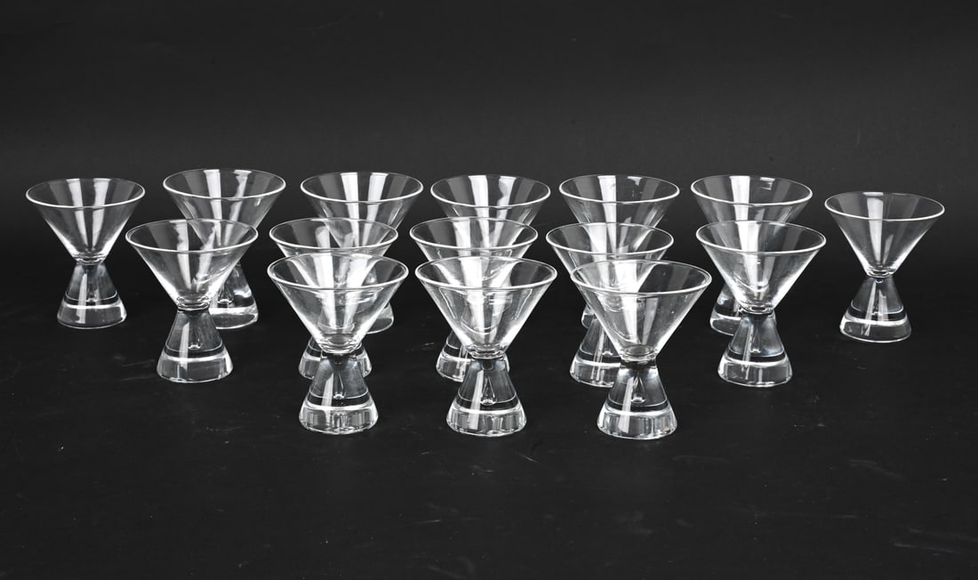 GEORGE THOMPSON STEUBEN TEARDROP MARTINI GLASSES: (15) Total. Blown glasses featuring a small teardrop bubble suspended within stem. Model 7826. Marked on undersides. Dimensions: H 4" x Dia 3.5" Condition: Light surface marks consistent with age and