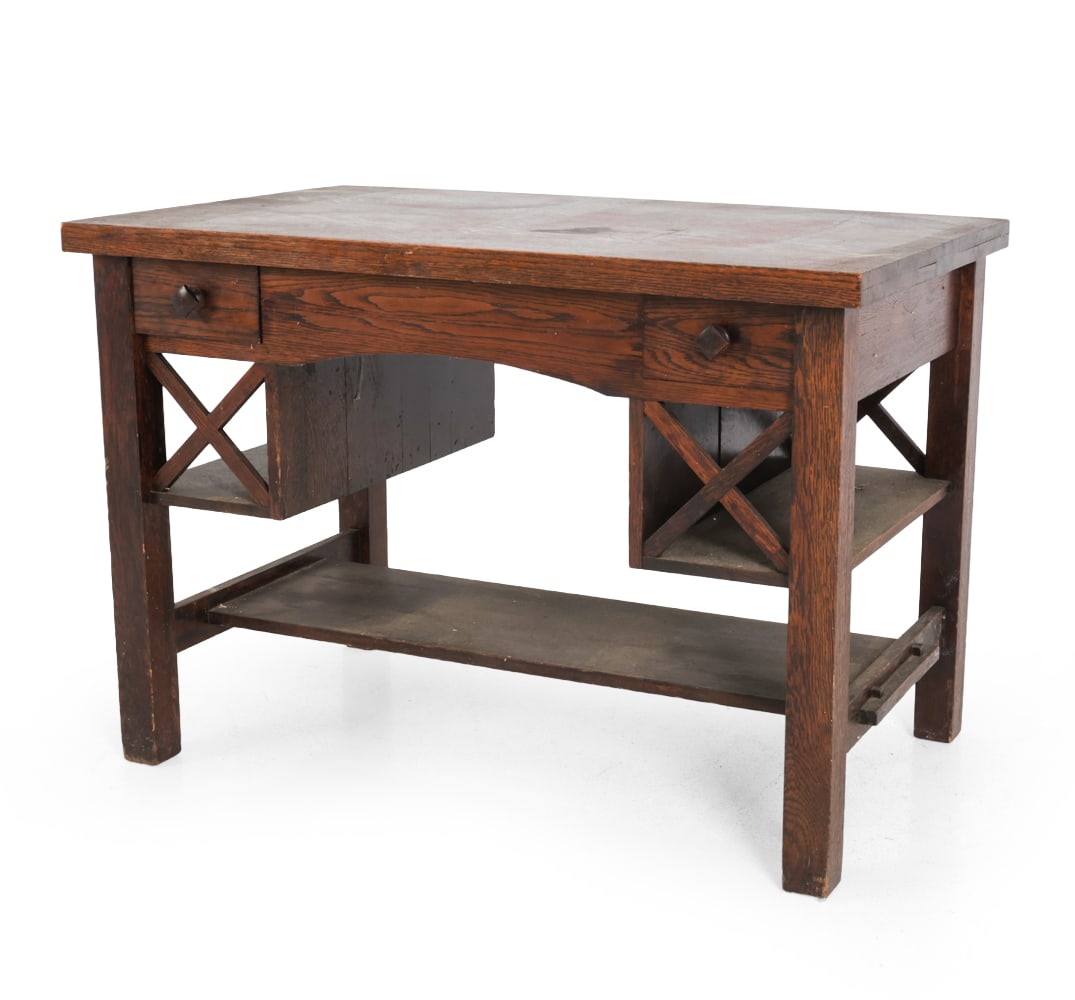 ARTS & CRAFTS MISSION OAK DESK: Early 20th century. Dimensions: H 29" x W 42" x D 25.75" Condition: Scuffs, discoloration, and chips on corner. Left drawer is cracked with a missing piece. Wear consistent with age and use.