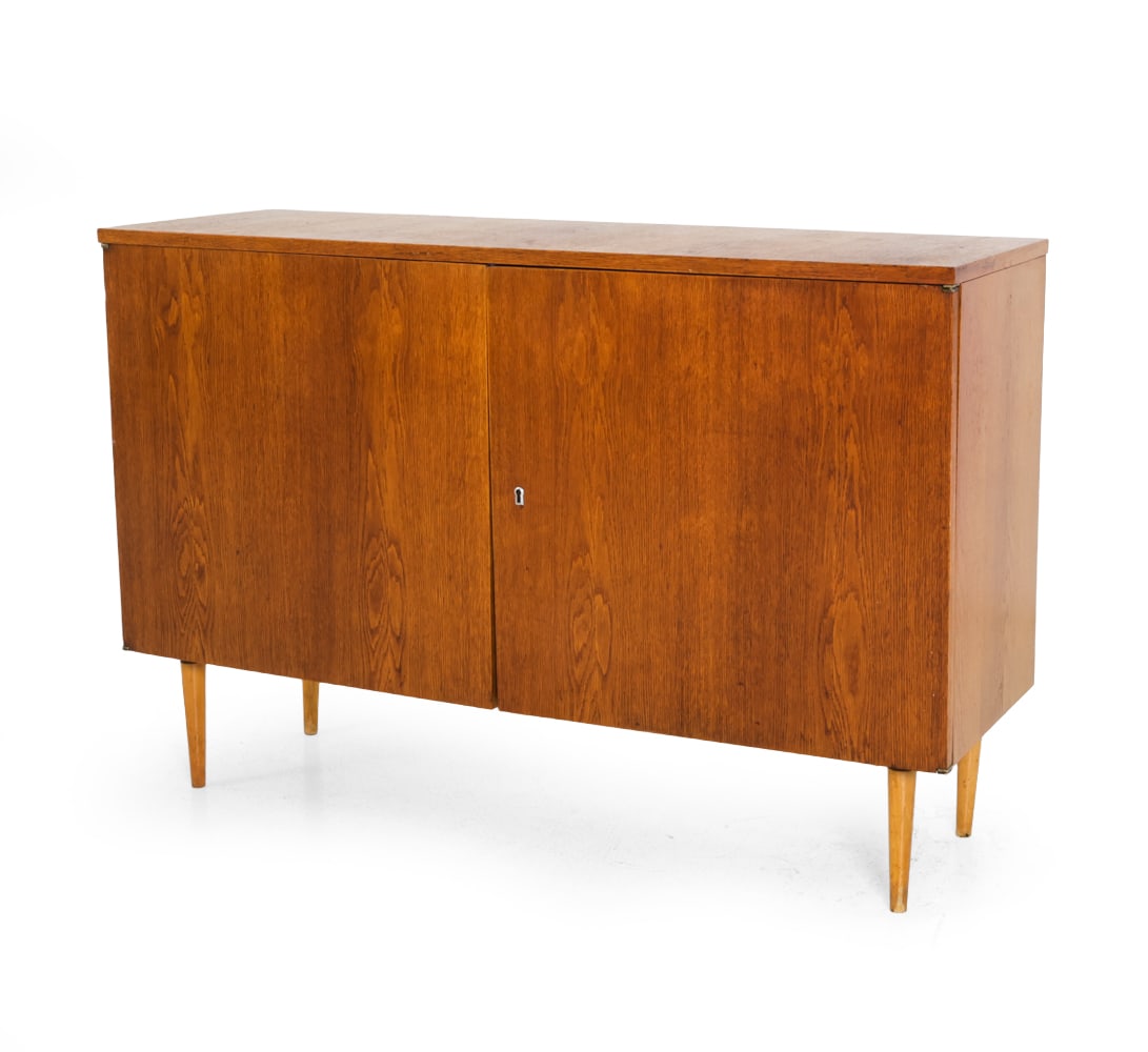 UP ZAVODY CZECH OAK CABINET C. 1960S: Key included. Marked to back. Czechoslovakia, circa 1960s. Dimensions: H 31" x W 46.75" x D 14.75" Condition: Scratches mainly on top surface. Scuffs. Watermarks. Wear consistent with age and use.