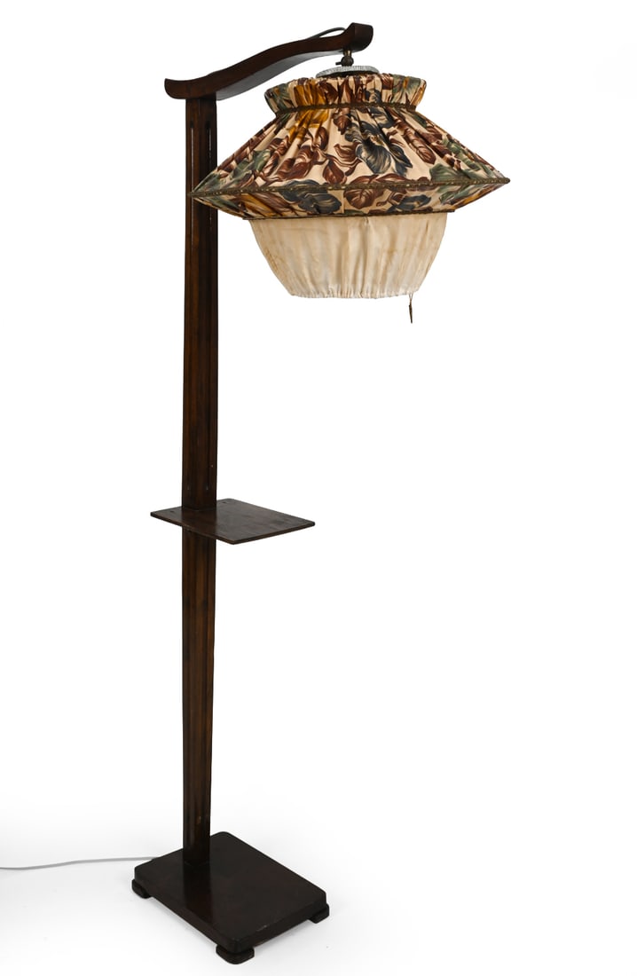 ART DECO GERMAN WALNUT FLOOR LAMP C. 1940S: Walnut with fabric shade. Germany, circa 1940s. Dimensions: H 63" x W 29" Condition: Scuffs, watermarks, and discoloration. Lampshade fabric is soiling. Wiring untested. European plug. Wear consistent