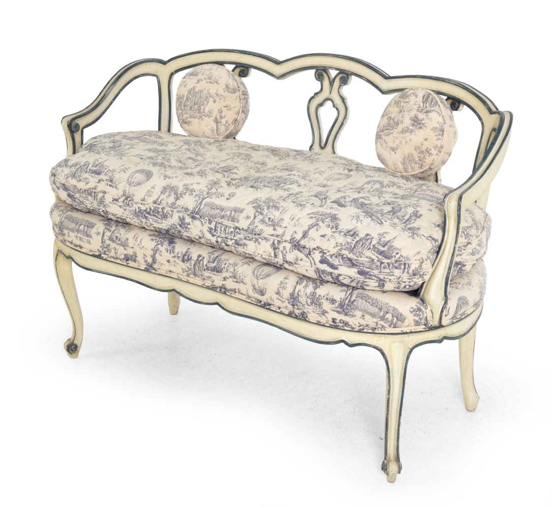 LOUIS XV-STYLE SETTEE: Carved white painted frame with blue toile de jouy pattern upholstery. Dimensions: SH 21.75 '' H 32.5 " x W 45 " x D 22.5 " Condition: wear consistent with age and use. Minor scuffs to edge and wear
