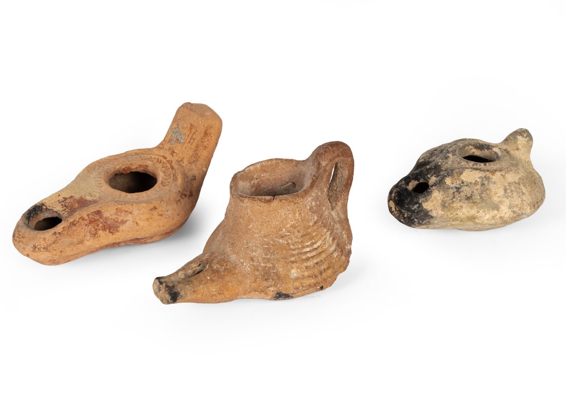 ANCIENT JERUSALEM OIL LAMP GROUPING: Grouping of (3) terracotta oil lamps. 2000 years old, from the Roman Period, Jerusalem. With Authentication certification from The Dolphin Shop LTD. Dimensions: (Largest) H 2.25" x W 3.75" x D 2.5" Co