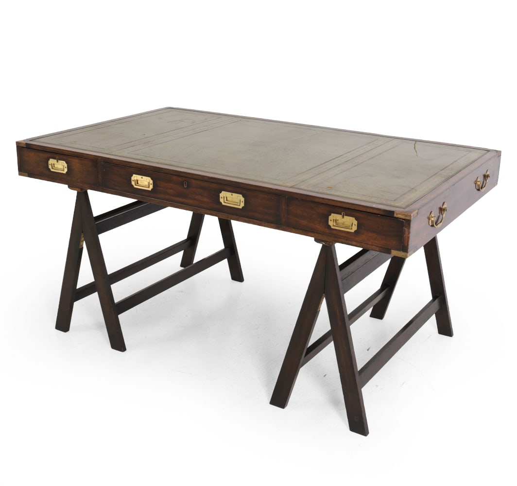 ENGLISH CAMPAIGN STYLE MAHOGANY DESK C. 1960S: Key included. Brass pulls. Tooled leather inlaid to top. Sits freely on legs. Dimensions: H 29.75" x W 60" x D 36". Condition: Scratches and scuffs to leather. Scratches and rubs to wood and patina to