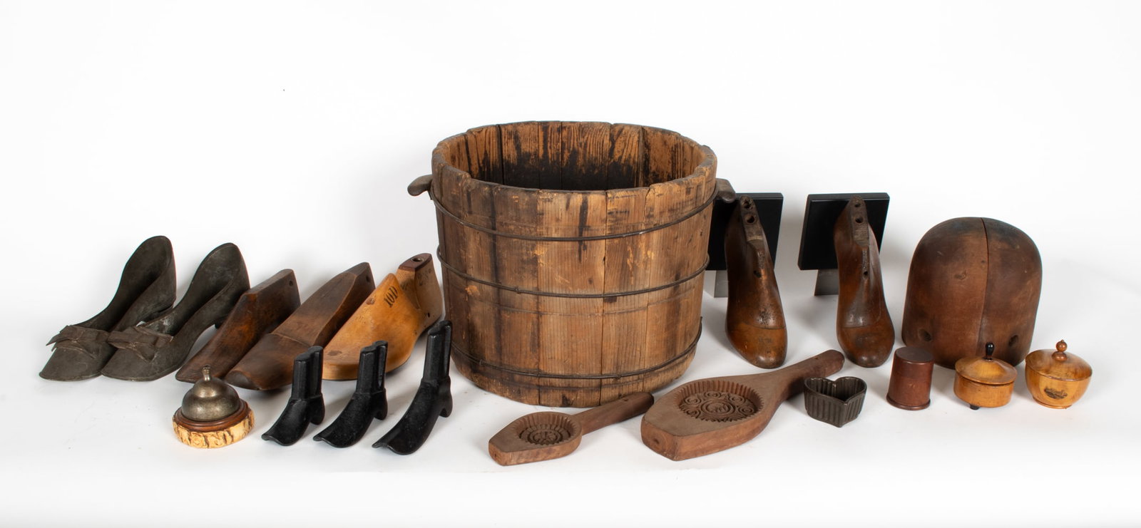 ANTIQUE AND VINTAGE WOODEN DECORATIVE GROUPING: Grouping of decorative items including cobbler molds, a bucket, a bell, and tools. Dimensions: (Bucket) H 10.5" x Dia 16" Condition: Wear consistent with age and use including, soiling, oxidation, spl