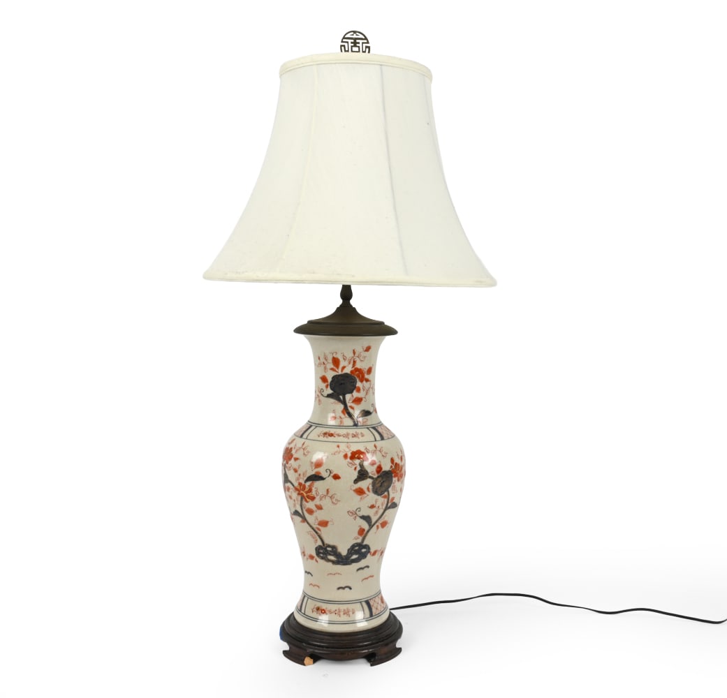 CHINOISERIE BLOSSSOM PORCELAIN TABLE LAMP: Flower motif porcelain table lamp. Dimensions: H 38" x Dia 18" Condition: Wear consistent with age and use. Untested. Scuffs to shade. rubs, patina to brass. Loss to base.