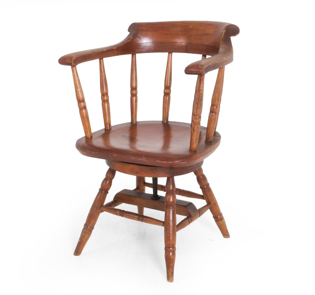 ANTIQUE BARREL BACK CAPTAIN'S CHAIR: Features a swiveling seat. Circa 1900s. Dimensions: SH 17'' x H 31" x W 23 " x D 20" Condition: Wear consistent with age and use. Scuffs and scratches, some staining, finish wear, soling spots. Fading
