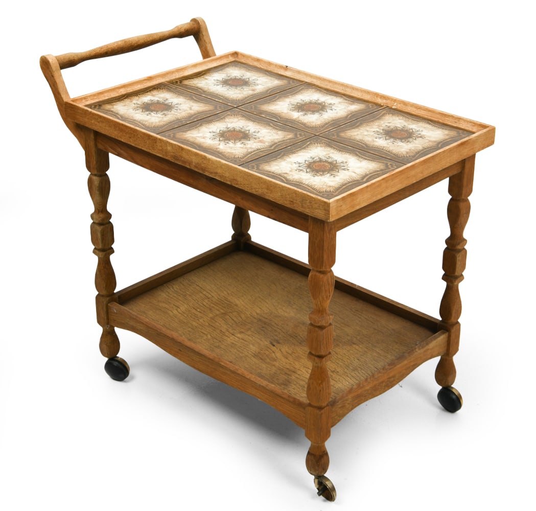 STYLE OF KJAERNULF DANISH OAK & TILE BAR CART: Oak frame and ceramic tile top. On casters. Denmark, circa 1970s. Dimensions: H 25.5" x W 17.5" x D 29" Condition: Minor scuffs on wood and tiles. Some wear of finish and watermarks on bottom shelf. W