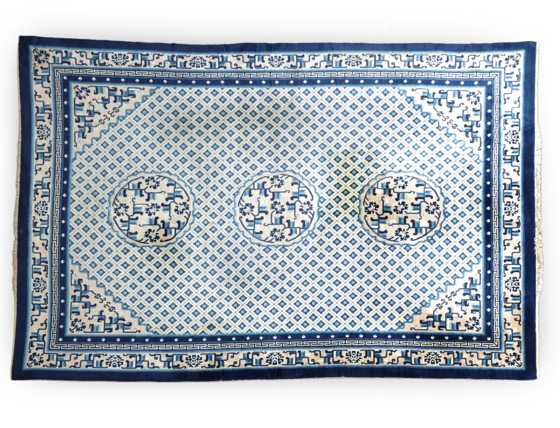 CHINESE ART DECO RUG: Blue Chinese art deco pattern with fringe trim. 20th century. Dimensions: H 107.5" x W 143" Condition: Discoloration and some fraying. Soiling, Wear consistent with age and use.