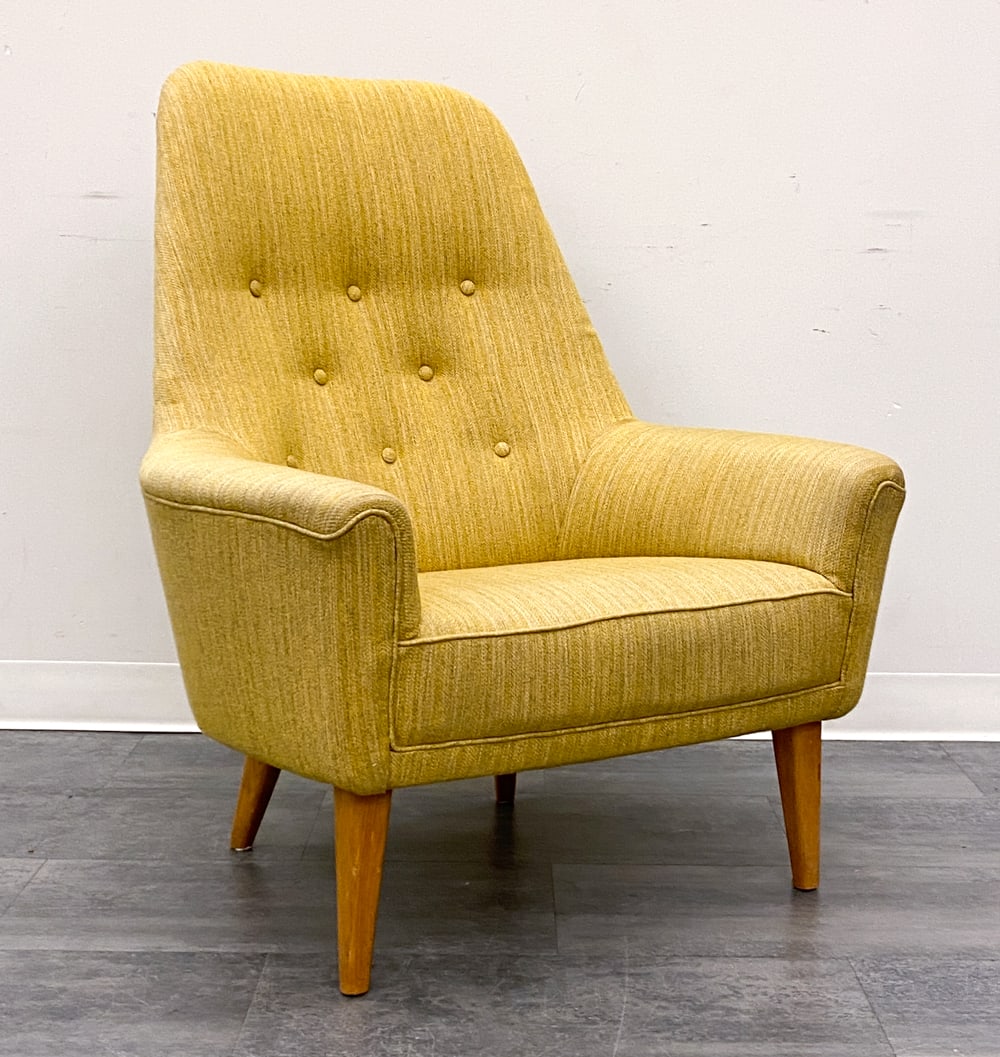 MALMSTEN STYLE SWEDISH LOUNGE CHAIR C. 1960S: Tufted yellow upholstery and teak legs. Sweden, circa 1960s. Dimensions: H 40" x W 32" x D 27" SH 16" Condition: Wear consistent with age and use. Scuffs, nicks to legs. Discoloration.