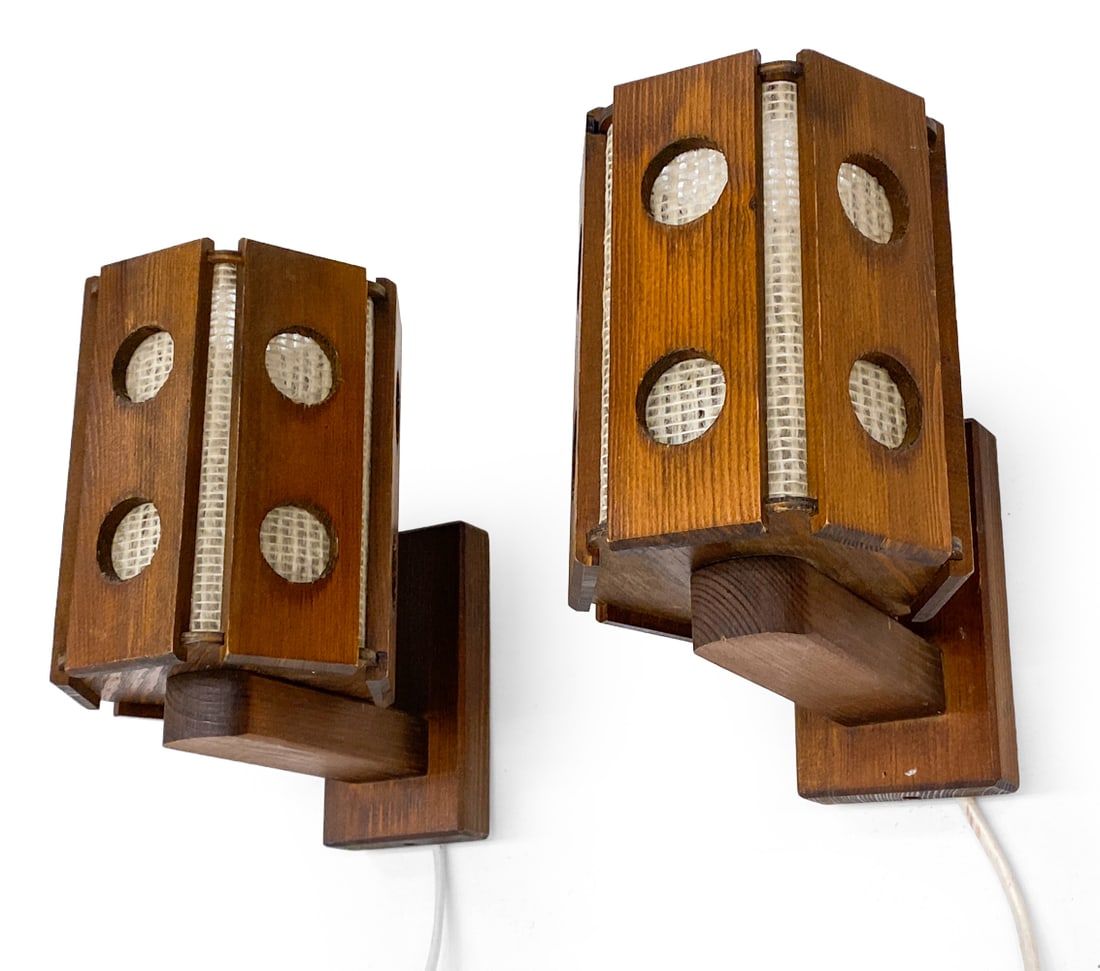 PAIR OF SWEDISH PINE WALL SCONCES C. 1970S: Dimensions: H 7.5" x W 5" x D 6.75" Condition: Sun fading. Losses to circular cutouts. Scuffs to finish. Wear consistent with age and use. Untested European plug.