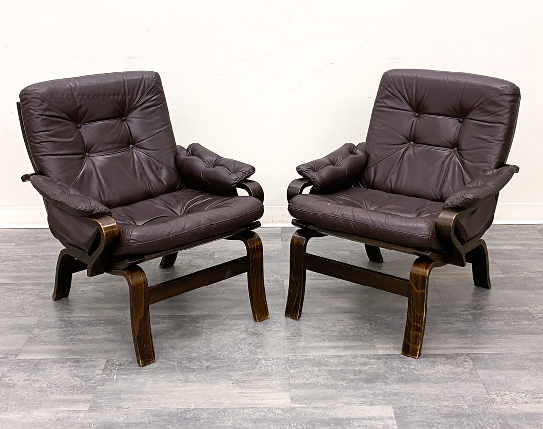 PAIR OF DANISH LEATHER LOUNGE CHAIRS C. 1970S: Stained beech frame and tufted leather upholstery. Denmark, circa 1970s. Dimensions: H 33" x W 28.5" x D 33" SH:18" Condition: Wear consistent with age and use. Nicks, rubs to legs. Creasing, scuffs, 