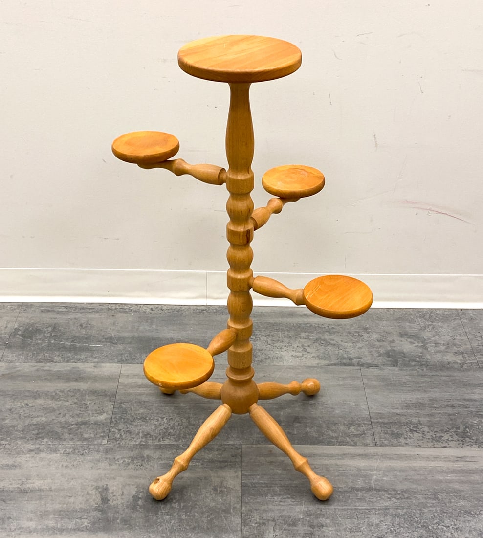 SCANDINAVIAN BEECH PLANT STAND C. 1970S: Five tiered shelf on a turned central column. Scandinavian, circa 1970s. Dimensions: H 35" x Dia 22" Condition: Wear consistent with age and use. Scuffs, rubs, nicks, minor soiling spots.