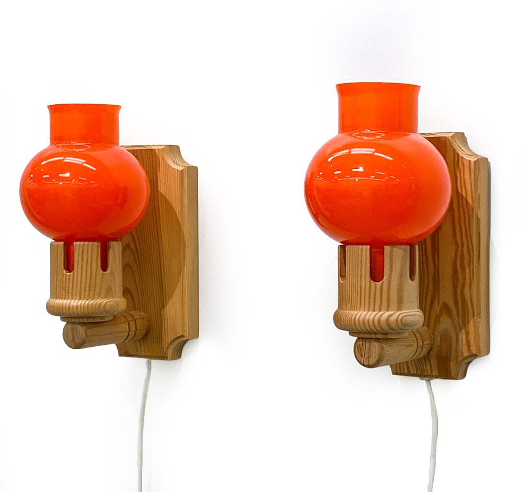 PAIR ATTR VITRIKA DANISH PINE & GLASS WALL SCONCES: Apparently unmarked. Denmark, circa 1960s. Dimensions: H 8" x W 6" x D 4" Condition: Wear consistent with age and use. Untested. European plug. Shade have fleabite chips to rims. Scuffs to wood.