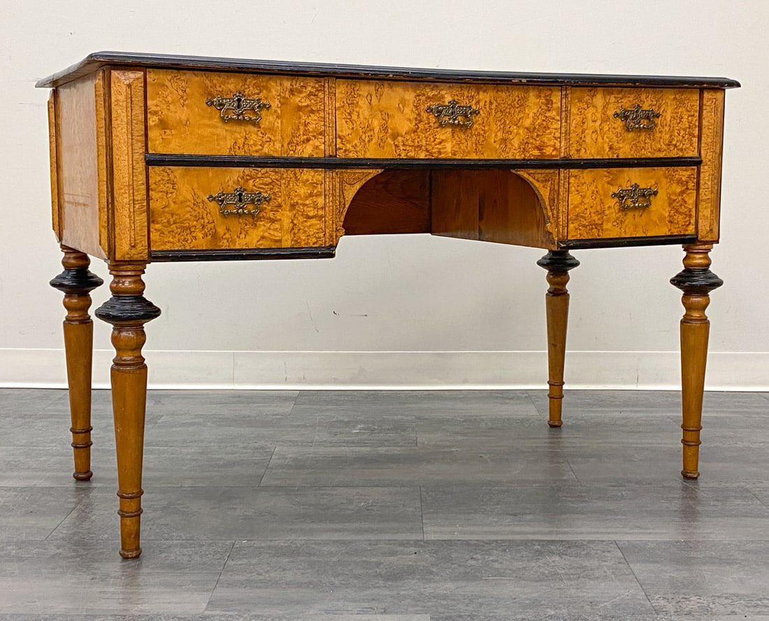 NEO-RENAISSANCE STYLE SWEDISH BIRCH DESK: Includes key. Features ebonized details and five drawers with brass pulls. Sweden, early 20th century. Dimensions: H 30" x W 46" x D 23" Condition: Wear consistent with age and use. Watermarks, fading