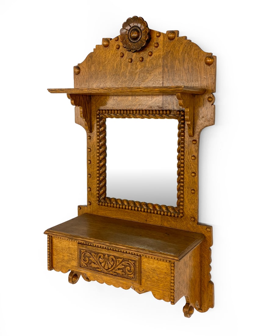 ANTIQUE SKONVIRKE STYLE DANISH OAK WALL MIRROR: Carved oak vanity mirror. Denmark, early 20th century. Dimensions: H 24" x W 13.5" x D 6" Condition: Sun fading to front. Losses and scuffs. Wear consistent with age and use.