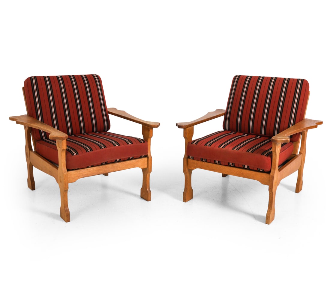 PAIR OF KJAERNULF STYLE DANISH OAK LOUNGE CHAIRS: Carved oak frame with striped upholstery. Denmark, circa 1960s. Dimensions: H 27.25" x W 30.5" x D 32" x SH 15" Condition: Scuffs, watermarks, wear of finish, and discoloration. Wear consistent with
