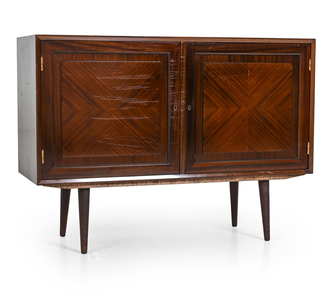 DECO STYLE SCANDINAVIAN MAHOGANY CABINET C. 1960S: Includes key. Two-door cabinet. Scandinavian, circa 1960s. Dimensions: H 34.75 " x W 47.5 " x D 17.5 " Condition: Sticky residue to front and top with surface marks. Finish wear to top surface.