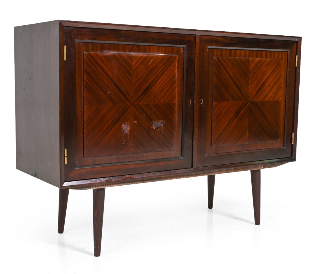 DECO STYLE SCANDINAVIAN MAHOGANY CABINET C. 1960S: Includes key. Two-door cabinet. Scandinavian, circa 1960s. Dimensions: H 34.75" x W 47.5" x L 17.5" Condition: Losses to finish on front of left door. Scuffs, scratches, fading to top surface. Wear
