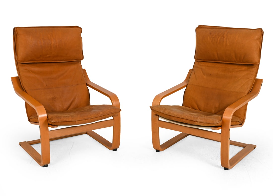 PAIR OF NAKAMURA FOR IKEA "POANG" LEATHER CHAIRS: Marked to frame. Designed by Noboru Nakamura for Ikea. Featuring bentwood beech frame and tan leather upholstery. Sweden. 20th century. Dimensions: H 41 " x W 27 " x D 33.5" x SH 16 " Condition: Scuff