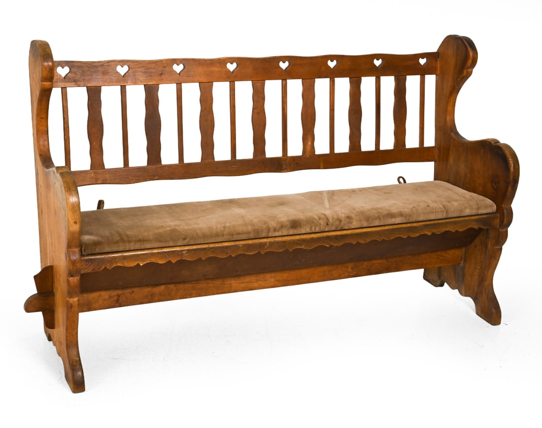 SWEDISH OAK HEART BACK BENCH C. 1950S: Carved oak with heart cutout back and velour upholstered seat. Shallow storage area under seating. Sweden, circa 1950s. Dimensions: H 41.5" x W 74.5" x D 19.75" x SH 19" Condition: Sun fading,