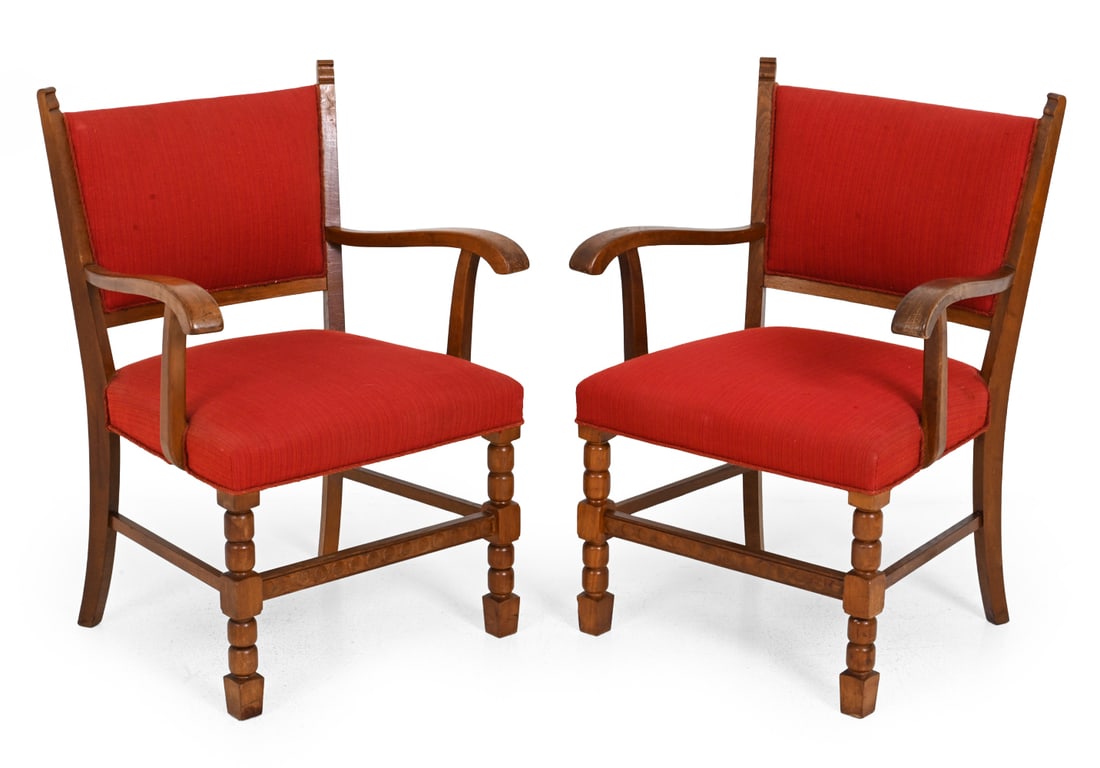 PAIR OF DANISH OAK ARMCHAIRS C. 1960S: Carved oak frame with turned legs and red upholstery. Denmark, circa 1960s. Dimensions: H 34.5 " x W 25.5 " x D 22 x SH 18 " Condition: Fading/scuffs to armrest. Tear to fabric border/fringe on back.