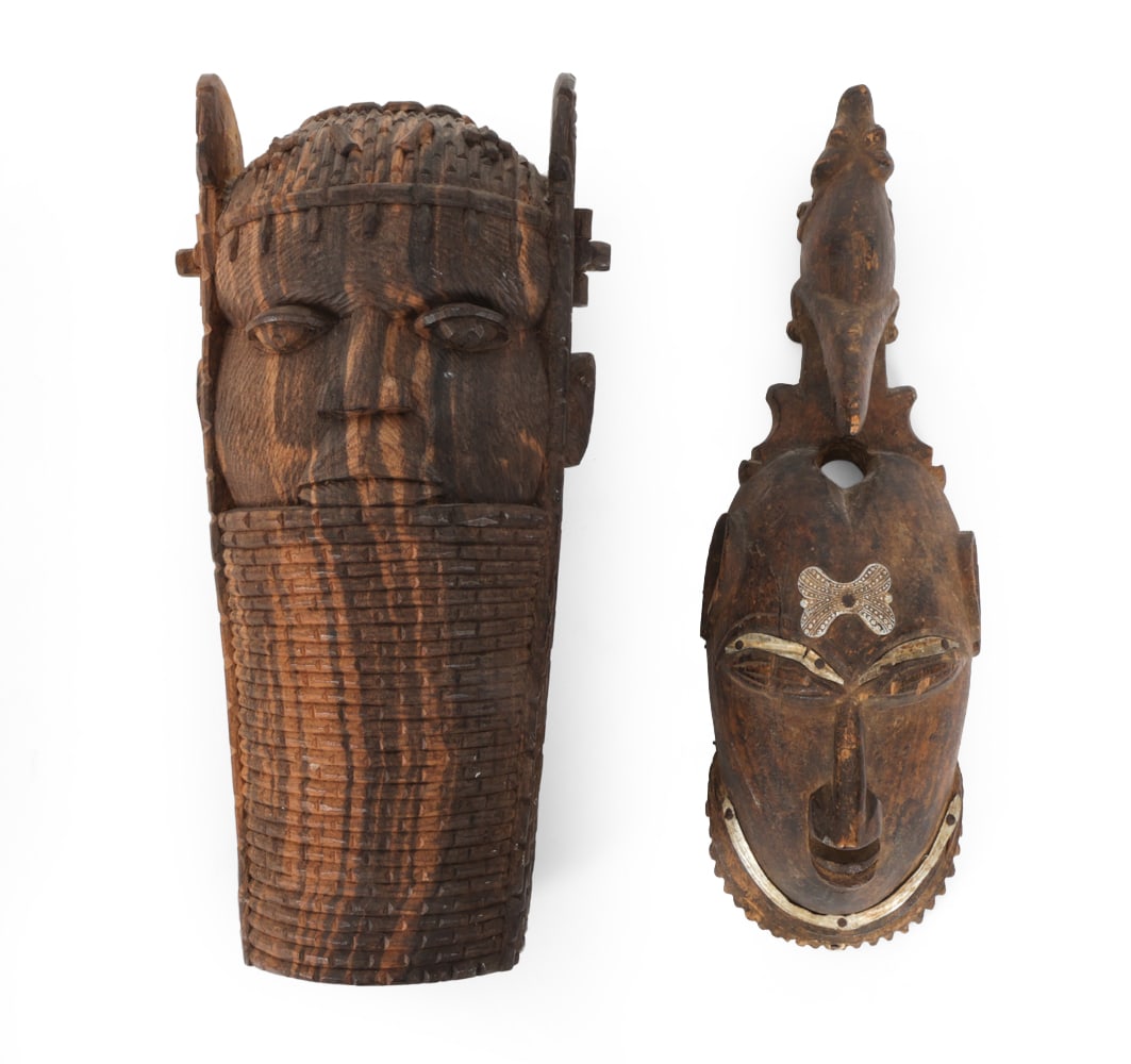 WEST AFRICAN TRIBAL MASKS INCL. BENIN & YAOURE: (2) total, including (1) ancestral head, modeled after altar portraits of an Oba (King) from the Benin Kingdom (Nigeria) and (1) African portrait face mask of the Yaoure people. Dimensions: H 12" x W 