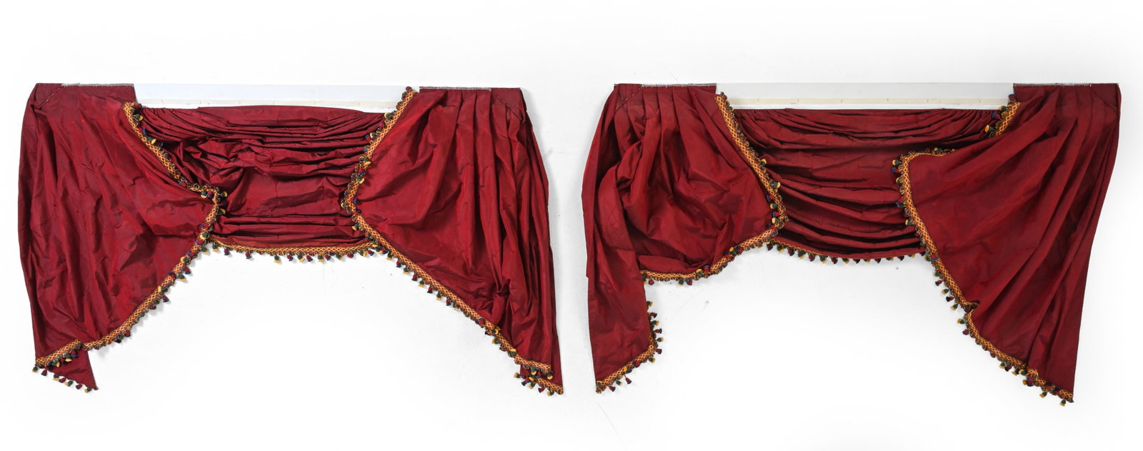 PAIR OF WATERFALL DRAPED WINDOW VALANCES: Featuring multicolor tassel accents. Dimensions: H 45''x W 69.5'' Condition: Wear consistent with age and use. Minor discoloration. Some light fading.