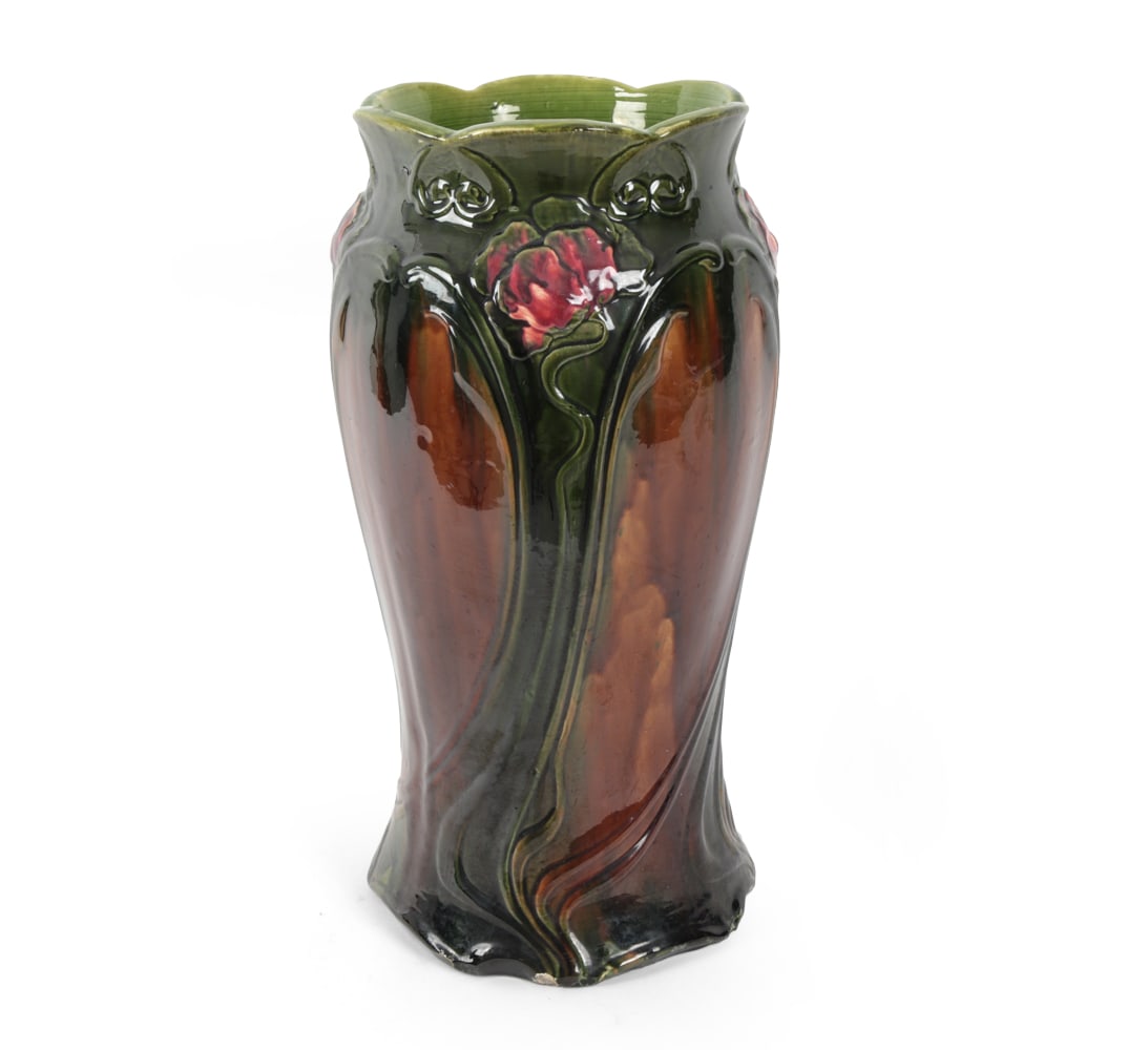ART NOUVEAU ART POTTERY UMBRELLA STAND: Glazed pottery with multi colored floral design. 20th century. Dimensions: H 22" x W 11.5" x D 11.5" Condition: Chips to bottom edges. Finish loss to surface. Wear consistent with age and use.