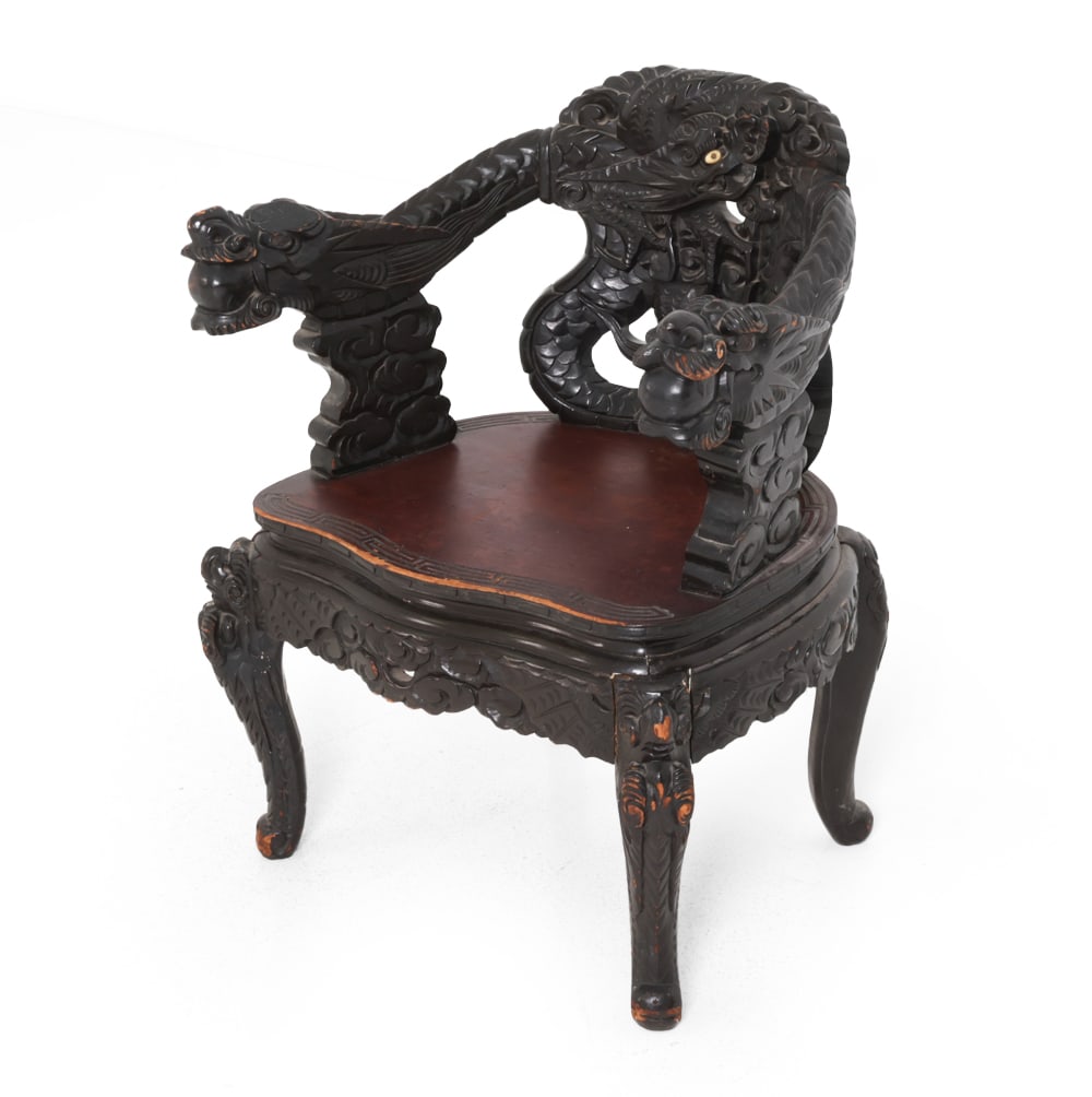 JAPANESE CARVED DRAGON EBONIZED ARMCHAIR: Appears to be Meiji period (1868-1912) import production. Ebonized hardwood frame. Carved imperial dragons across the crest rail and back support with eye inlay. Dimensions: H 35" x W 28" x D 20" SH