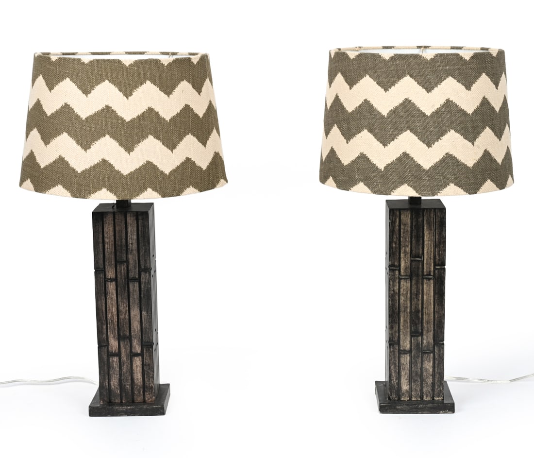 PAIR OF CONTEMPORARY TABLE LAMPS: Designed with a faux stacked wood base. Dimensions: (To shade) H 27.5" x Dia 14" Condition: Couple spots to soiling and warping to shades. wear consistent with age and use. Untested.