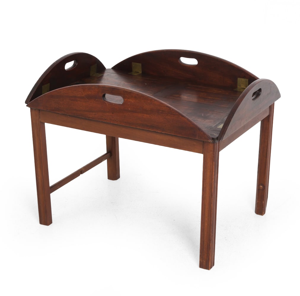 CHIPPENDALE STYLE MAHOGANY FOLDABLE BUTLER TABLE: Mahogany with carved legs, foldable side, brass hardware, and casters. Early 20th century. Dimensions: H 18.5" x W 38" x D 30" Condition: Scuffs, dings, watermarks, patina to hardware, and