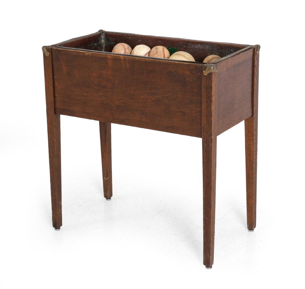 ARTS AND CRAFTS OAK PLANTER: Along with a grouping of baseballs and softballs. Dimensions: (Planter) H 25.5" x W 24.25" x D 13.5" (Baseball) Dia 2.75" (Softball) Dia 4" Condition: Wear consistent with age and use. Dirt soiling,
