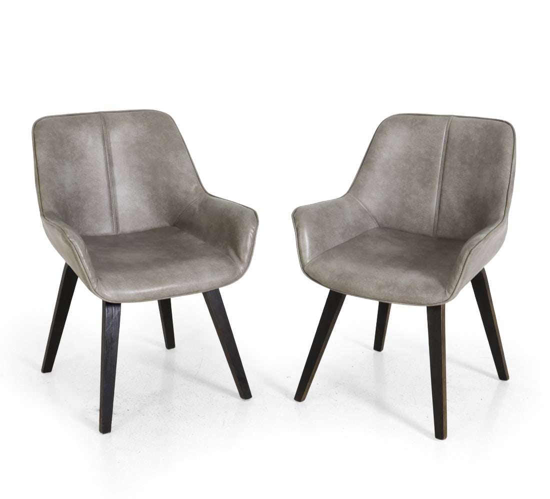 PAIR SIDE CHAIRS: Shell shaped seating with a vertical accent seam in faux leather upholstery. Tapered dark stained oak legs. Dimensions: H 33" x W 24" x D 22" x SH 16" Condition: Wear consistent with age and use.