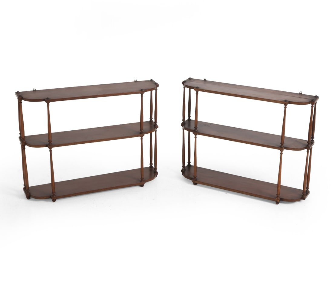 PAIR ANTIQUE MAHOGANY TIERED WALL SHELVES: Mahogany three tiered shelves with turned spindles. Early 20th century. Dimensions: H 20" x W 26.5" x D 6.5" Condition: Scuffs, dings, watermarks, and wear of finish. One shelf has multiple repaired s