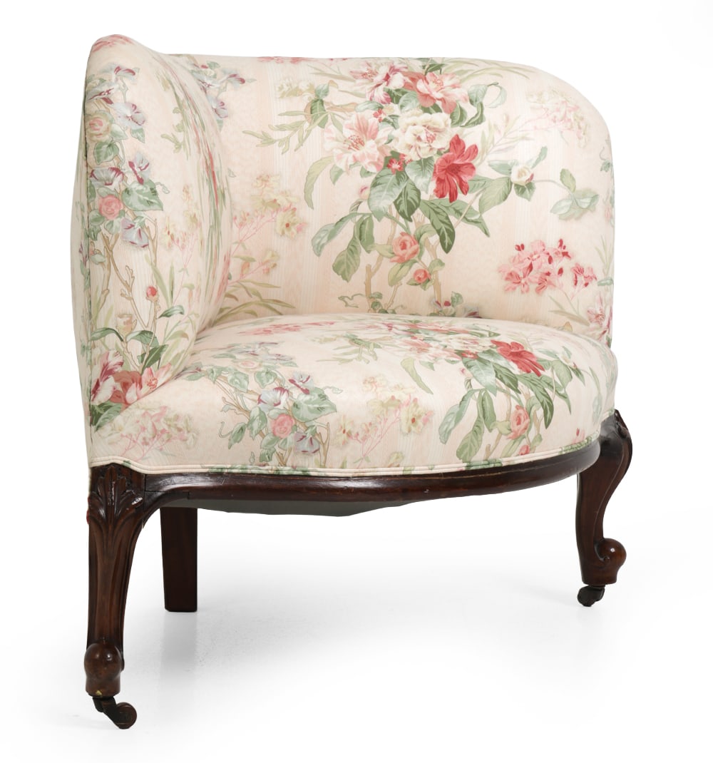 VICTORIAN CORNER CHAIR: Carved base and floral upholstery. Late 19th century. Dimensions: SH 14 " x H 31 " x W 36 " x D 27 " Condition: Wear consistent with age and use. Nicks, scuffs and dings to legs. Finish loss and crack