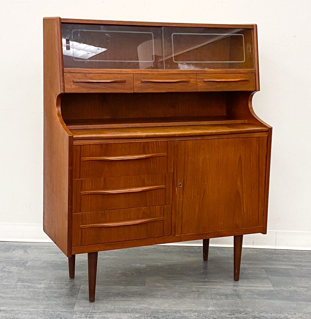 ATTR. SEJLING SKABE DANISH TEAK SECRETARY DESK: Key included. Double sliding glass doors and drawers with integrated pulls. Apparently unmarked. Denmark, circa 1960s. Dimensions: H 49" x W 39.5" x D 16" Condition: Wear consistent with age and use. 