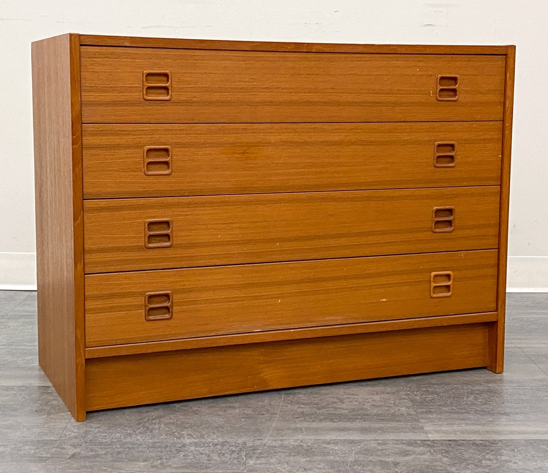 SEJLING SKABE DANISH TEAK CHEST OF DRAWERS 1960S: Four-drawers chest with carved handles. Apparently unmarked. Denmark, circa 1960s. Dimensions: H 26" x W 34.5" x D 15.75" Condition: Wear consistent with age and use. Fading, scuffs, some nicks,