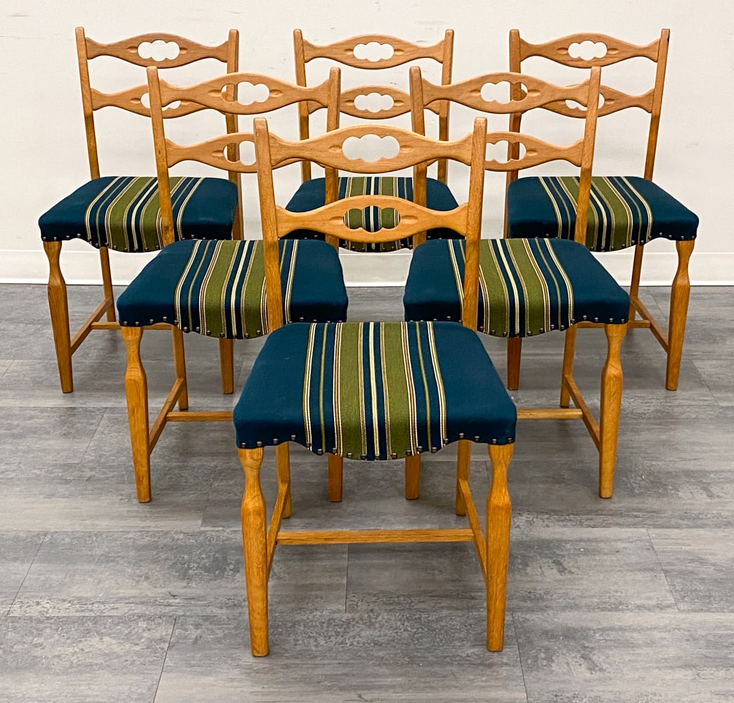 (6) HENNING KJAERNULF DANISH OAK DINING CHAIRS: Carved oak frame and striped upholstery. Denmark, circa 1970s. Dimensions: H 35" x W 18" x D 19" x SH 18.5" Condition: Wear consistent with age and use. Scuffs, fading, minor soiling spots. Scuffs, ni