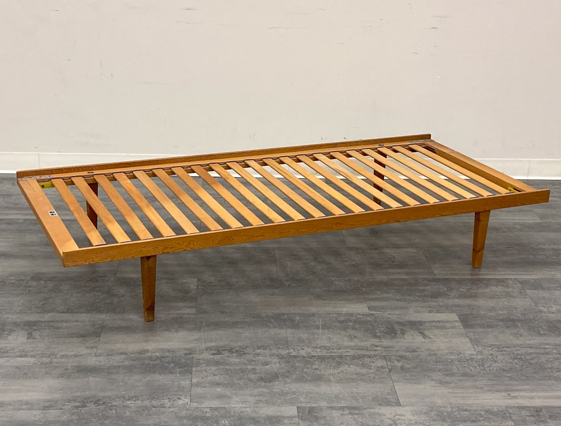 HORSNAES DANISH PINE DAYBED FRAME C. 1960S: Marked to frame. Denmark, circa 1960s. Dimensions: H 12" x W 75" x D 34.5" Condition: Wear consistent with age and use. Scuffs, fading, Some paint marks, nicks to legs.