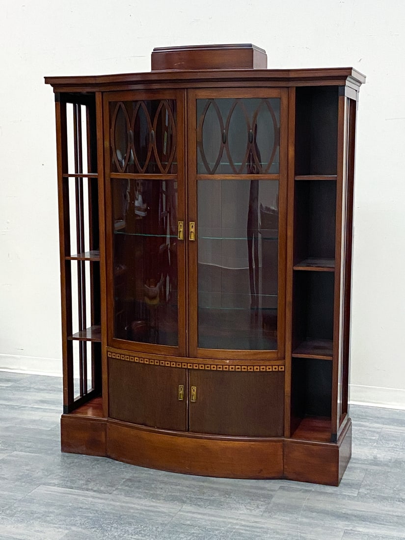 SCANDINAVIAN MAHOGANY BOOKCASE DISPLAY CABINET: Includes key. Features glass doors, geometric inlaid marquetry trim and flanking open side shelving unit. Early 20th century. Dimensions: H 69.25" x W 50.25" x D 18" Condition: Wear consistent with ag