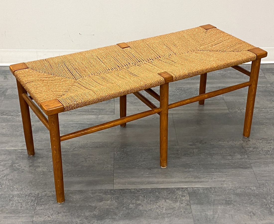 SCANDINAVIAN CORD & OAK BENCH C. 1950S: Woven paper cord seat and oak frame. Scandinavian, circa 1950s. Dimensions: H 17.5" x W 40.75" x D 17" Condition: Wear consistent with age and use. Scuffs, rubs, scratches to legs. Fading to top. Stre