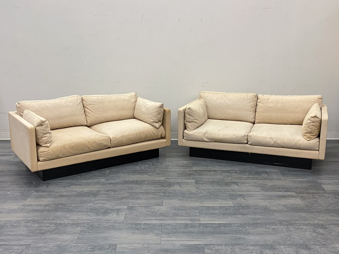 PAIR ATTR. ERIK JORGENSEN "EJ 220" LOVESEAT SOFAS: Low-profile silhouette and black recessed plinth base. Apparently unmarked. Denmark, circa 1970s. Dimensions: H 24" x W 63.5" x D 33.5" x SH 14" Condition: Wear consistent with age and use. Soiling, s