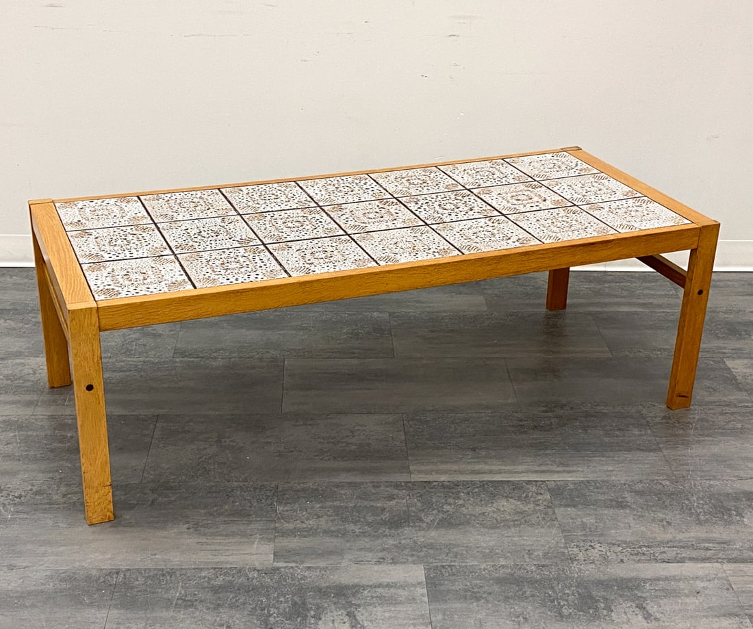 DANISH OAK & TILE COFFEE TABLE C. 1960S: Oak frame and tile top. Denmark, circa 1960s. Dimensions: H19.75" x W 59.75" x D 26" Condition: Wear consistent with age and use. Scuffs, fading. Discoloration to legs.